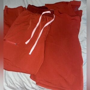 Figs. Color is auburn! High waisted skinny yola scrub pants/ Rafaela scrub top!